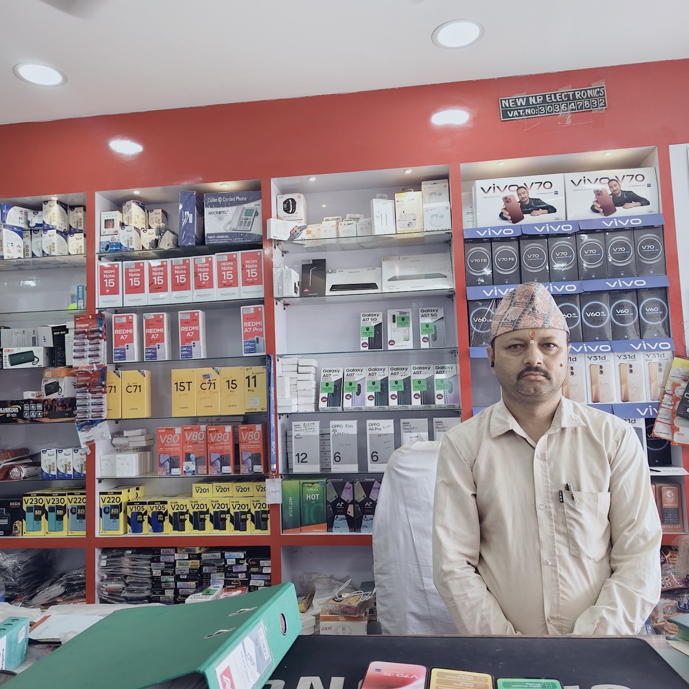 Netra Prasad Paudel, owner, at the New NP Electronics sales counter